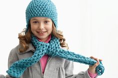 Child wearing crocheted scarf and hat