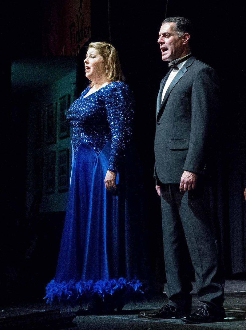Photo of a man and woman singing