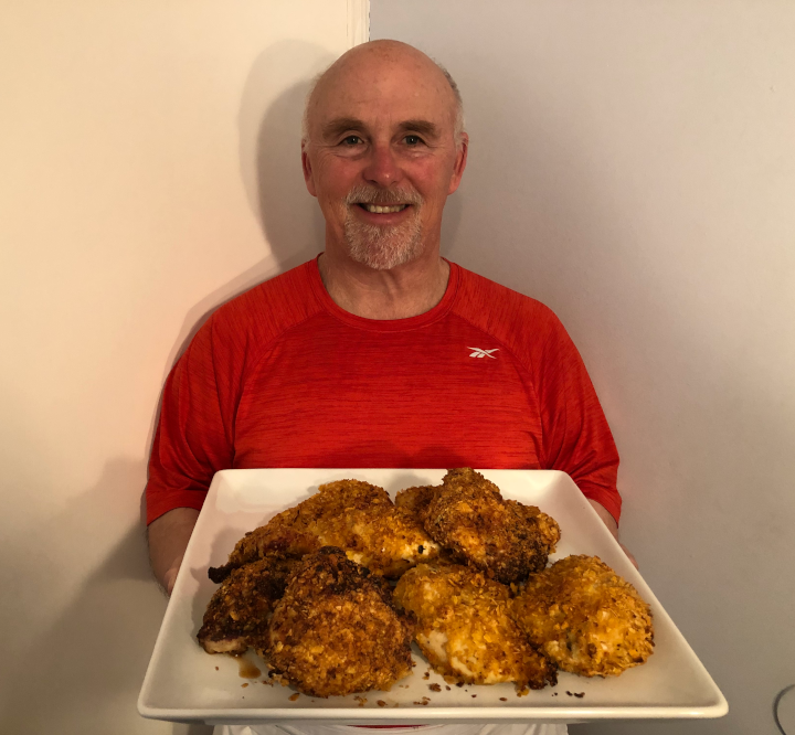 Photo of Chef Rob holding a plate of Baked Buttermilk Fried Chicken.