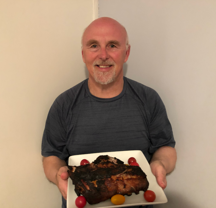 Chef Rob holding a plate of Hoisin Honey BBQ Ribs