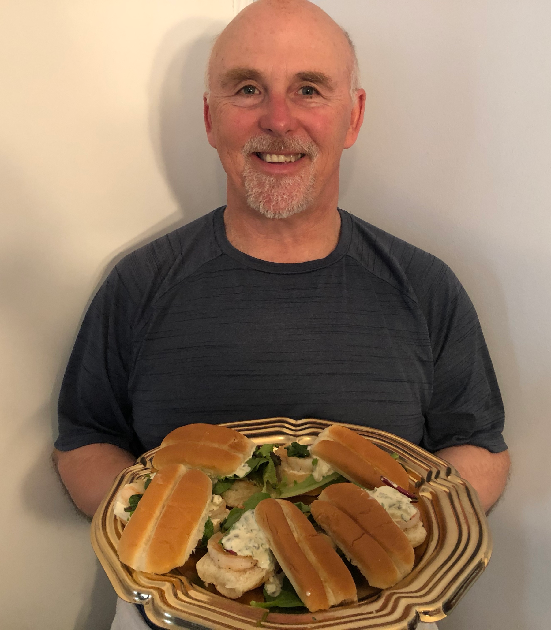 Photo of Chef Rob holding a plate of Shrimp Sliders.