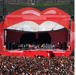 Photo of a stage for a Rolling Stones concert that is framed by a open mouth.