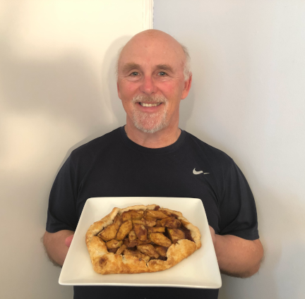 Photo of Chef Rob holding a plate with a Salted Caramel Apple Galette.