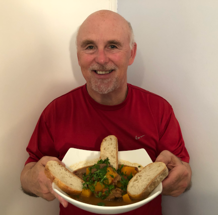 Photo of Chef Rob holding a bowl of Beef & Butternut Squash Stew.