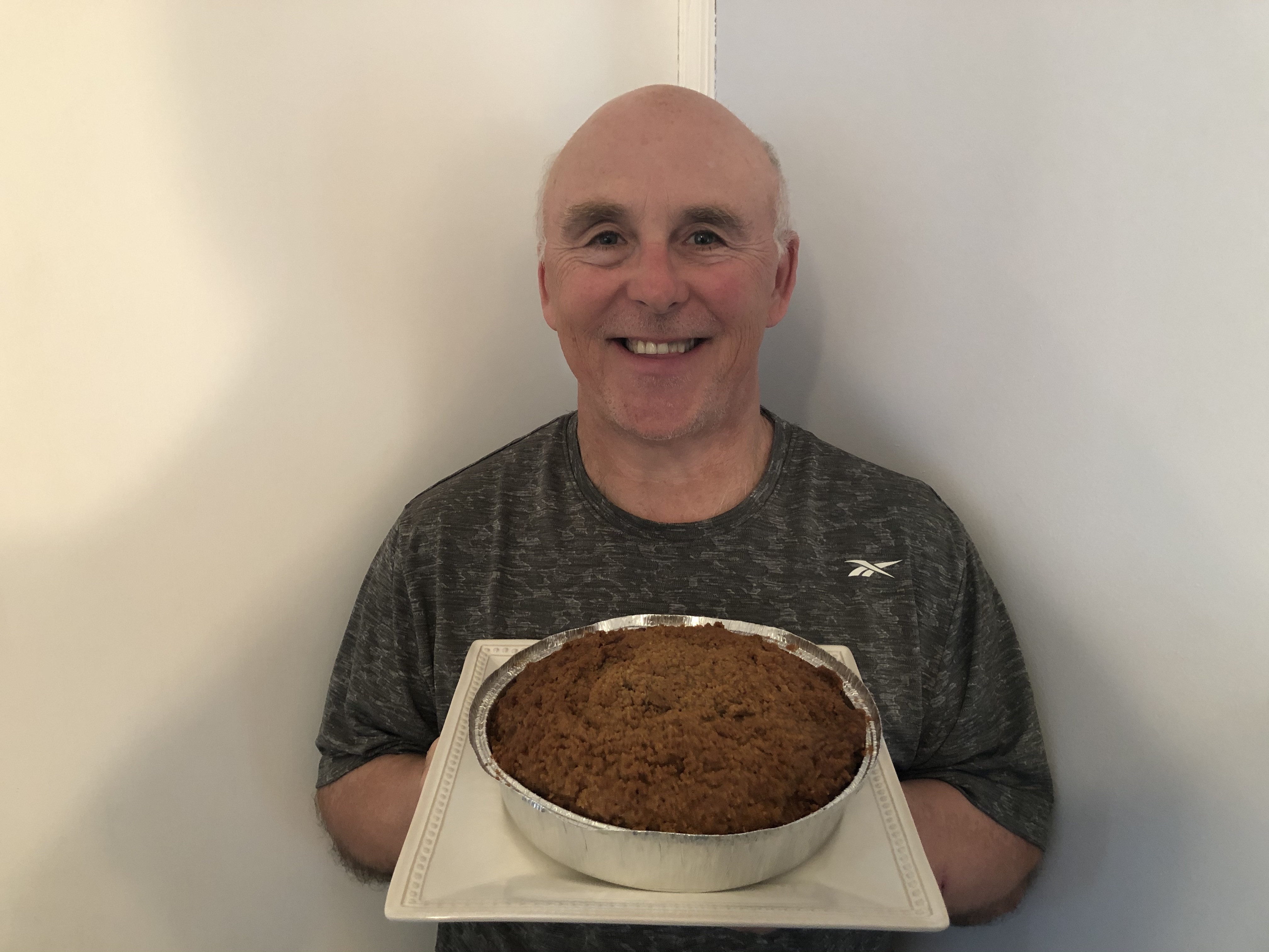 A photo of Chef Rob holding a Pumpkin Crumb Cake.