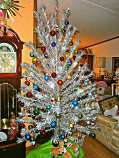 Photo of a decorated aluminum Christmas tree.