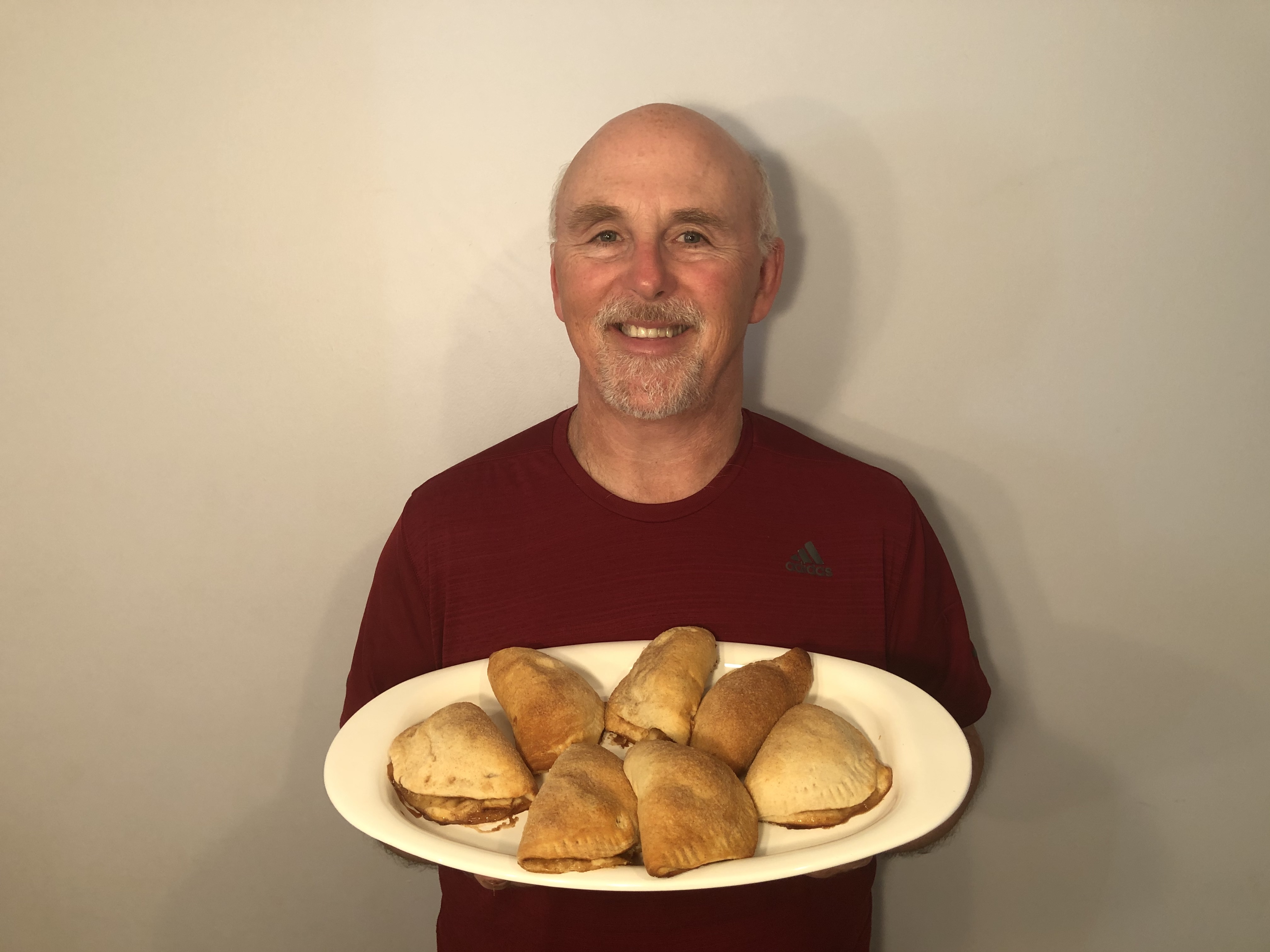 Chef Rob holding a plate of Apple Pie Calzones.