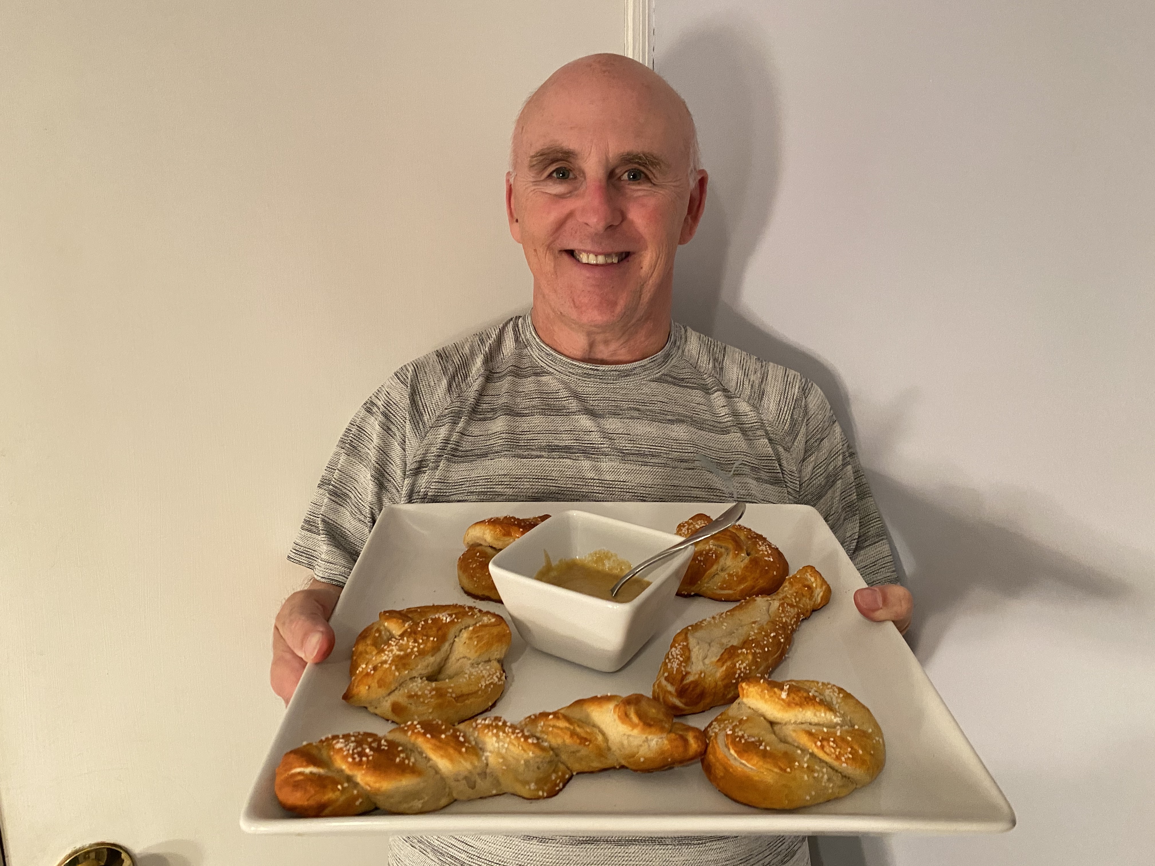 Chef Rob holding a plate of soft pretzels.