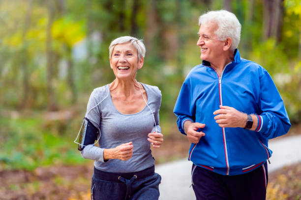Photo of an older couple power walking.