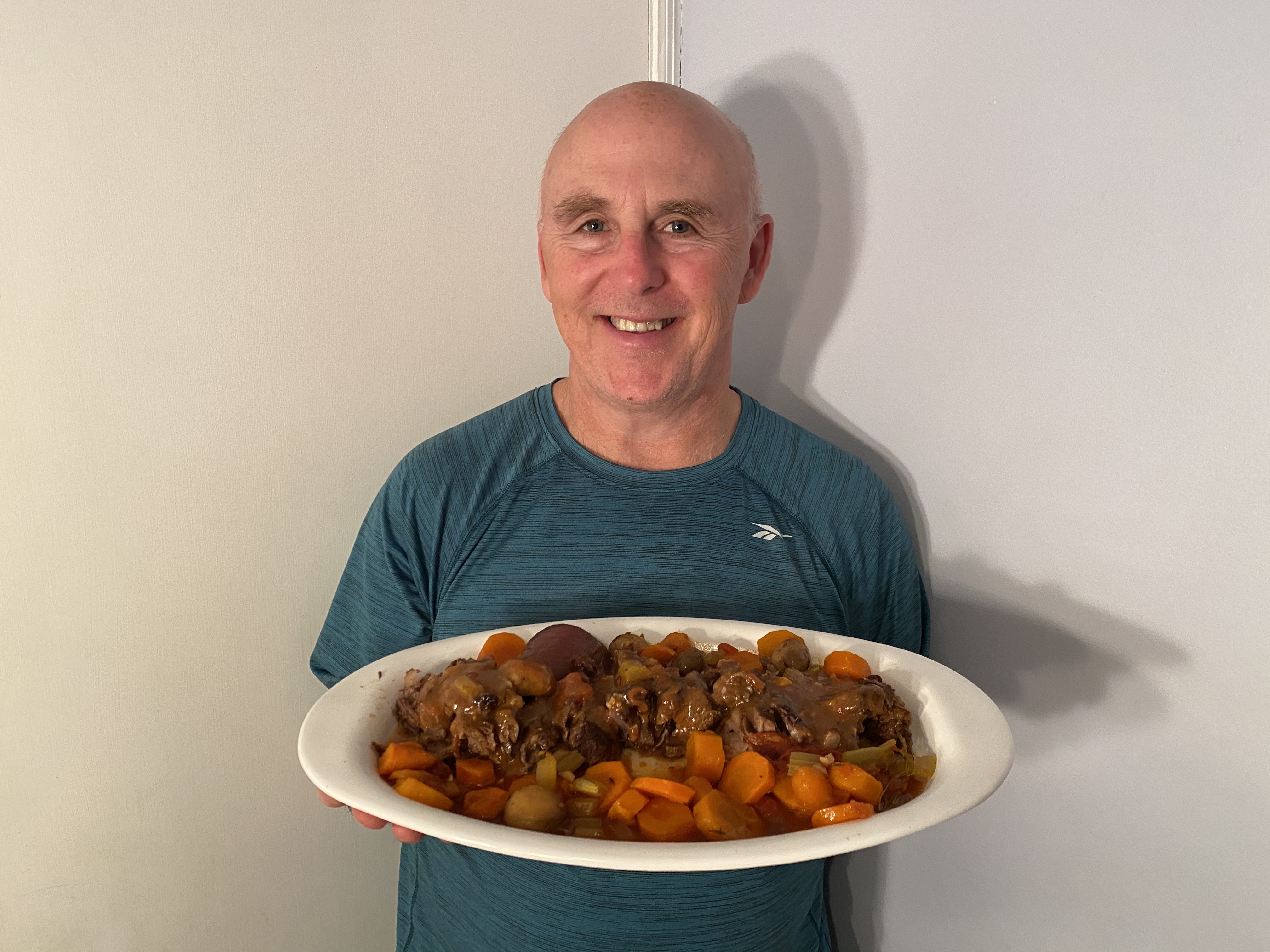 Photo of Chef Rob holding a plate of Winter Braised Pot Roast.