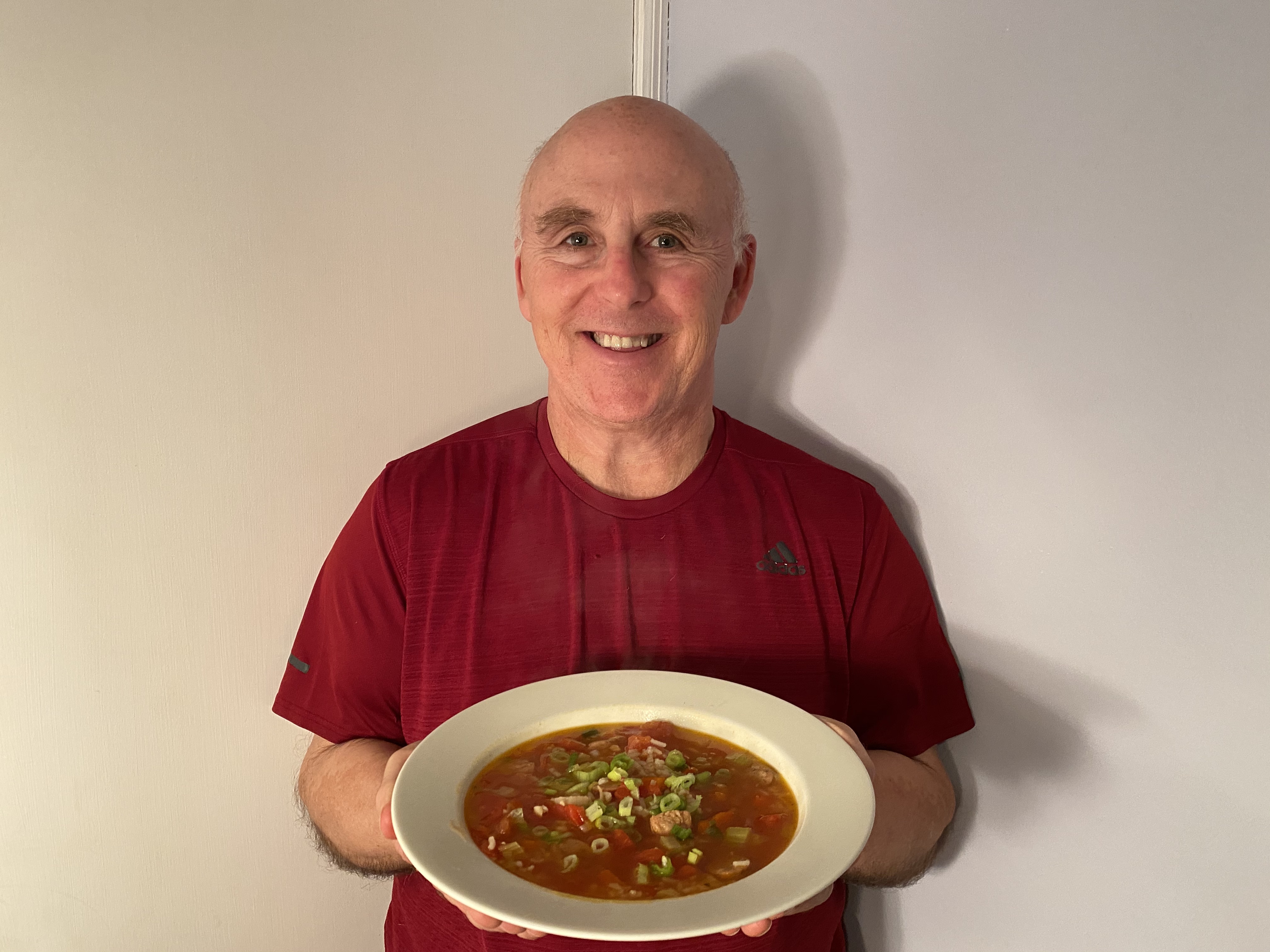Photo of Chef Rob holding a bowl of Jambalaya Soup.