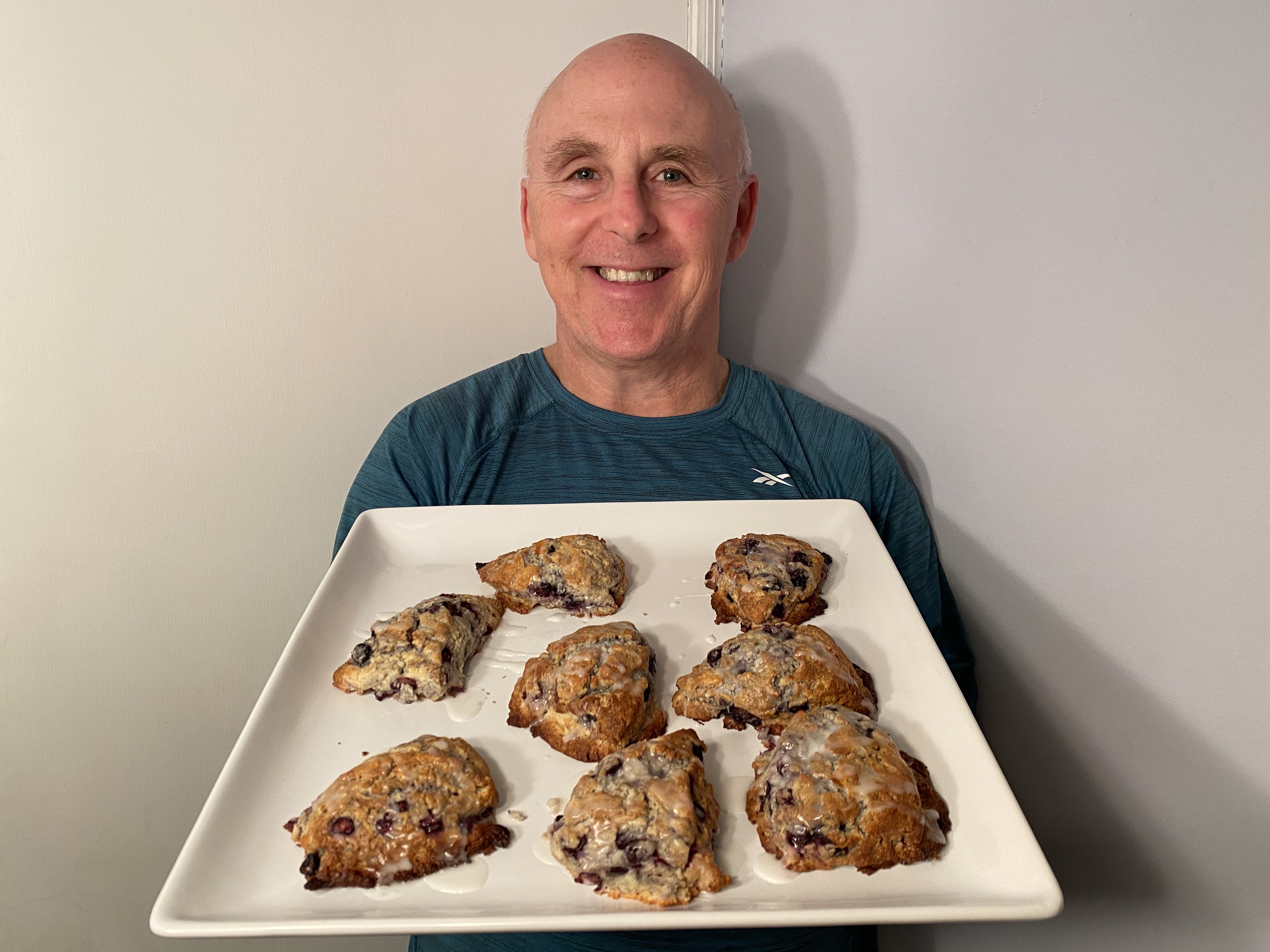 Photo of Chef Rob holding a plate of Spring Lemon-Blueberry Scones.