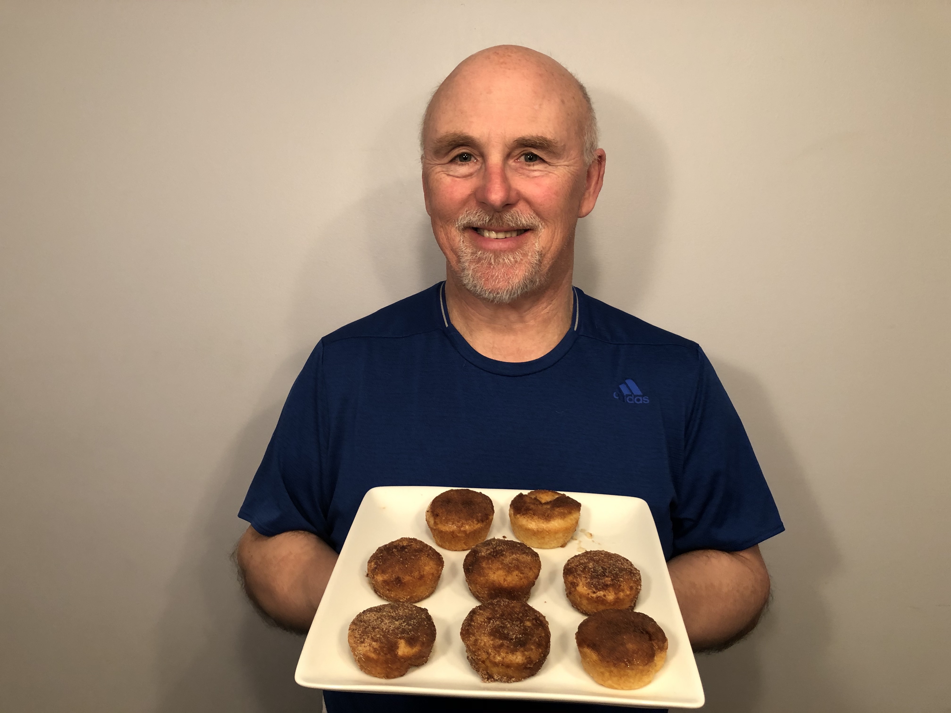 A photo of Chef Rob holding a plate of Churros Muffins.