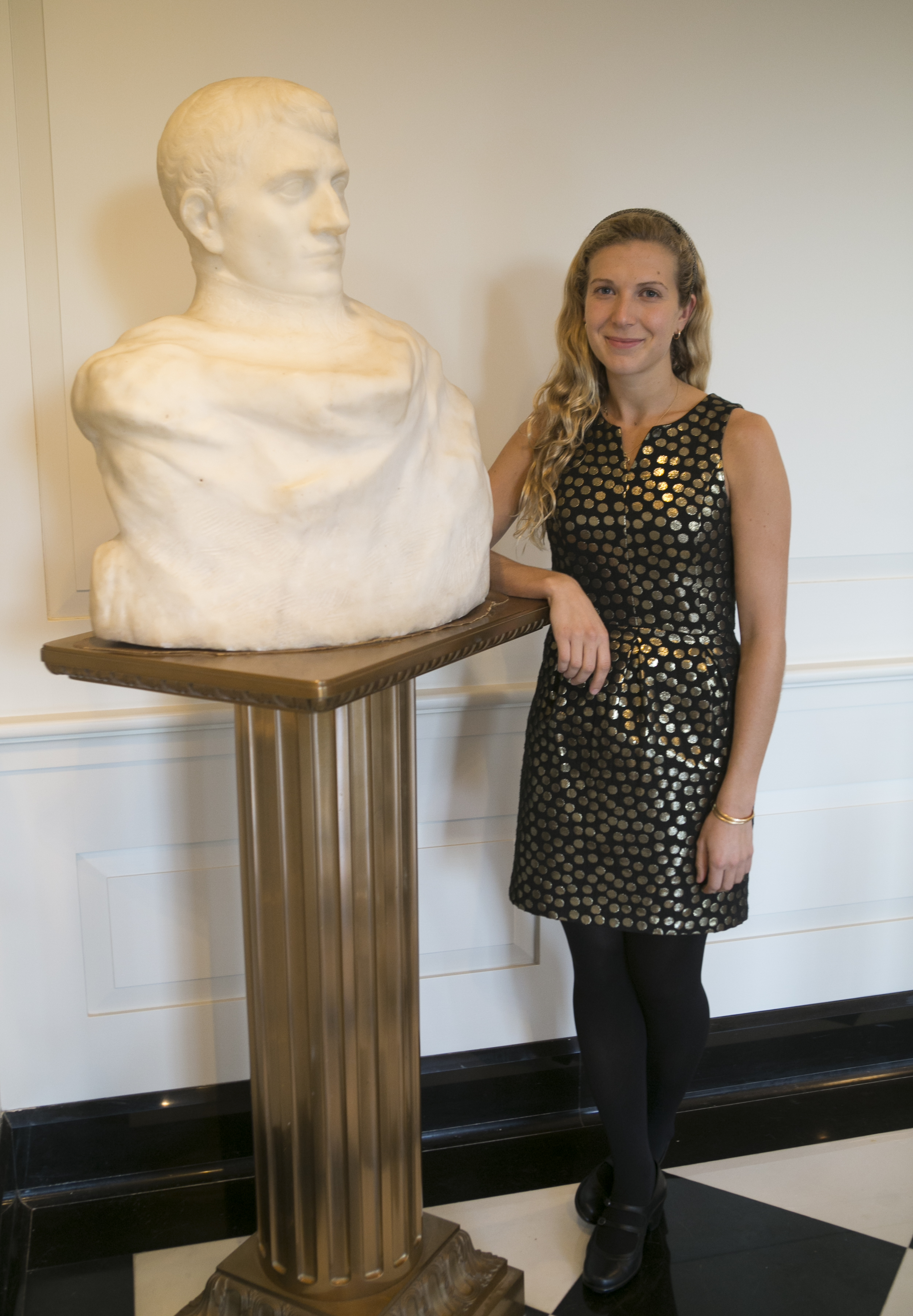 A photo of curator Mallory Mortillaro with the Rodin sculpture.