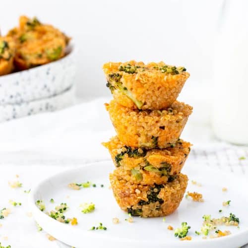 A photo of three Broccoli Cheddar Quinoa Bites stacked on a white plate.