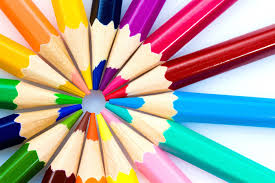 A photo of colored pencils arranged in a circle, tips touching in the middle.