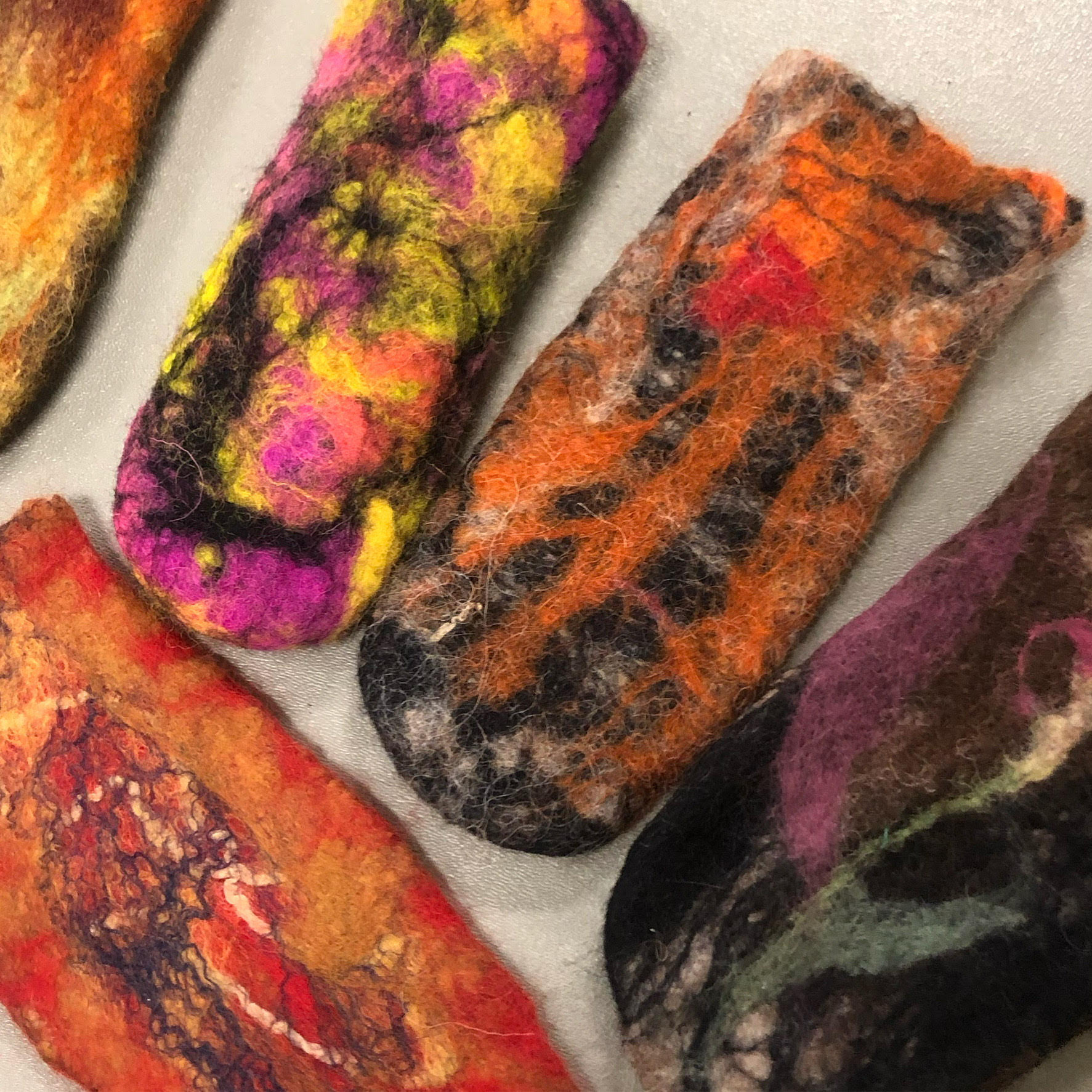 A photo of eyeglass cases made from felted wool.