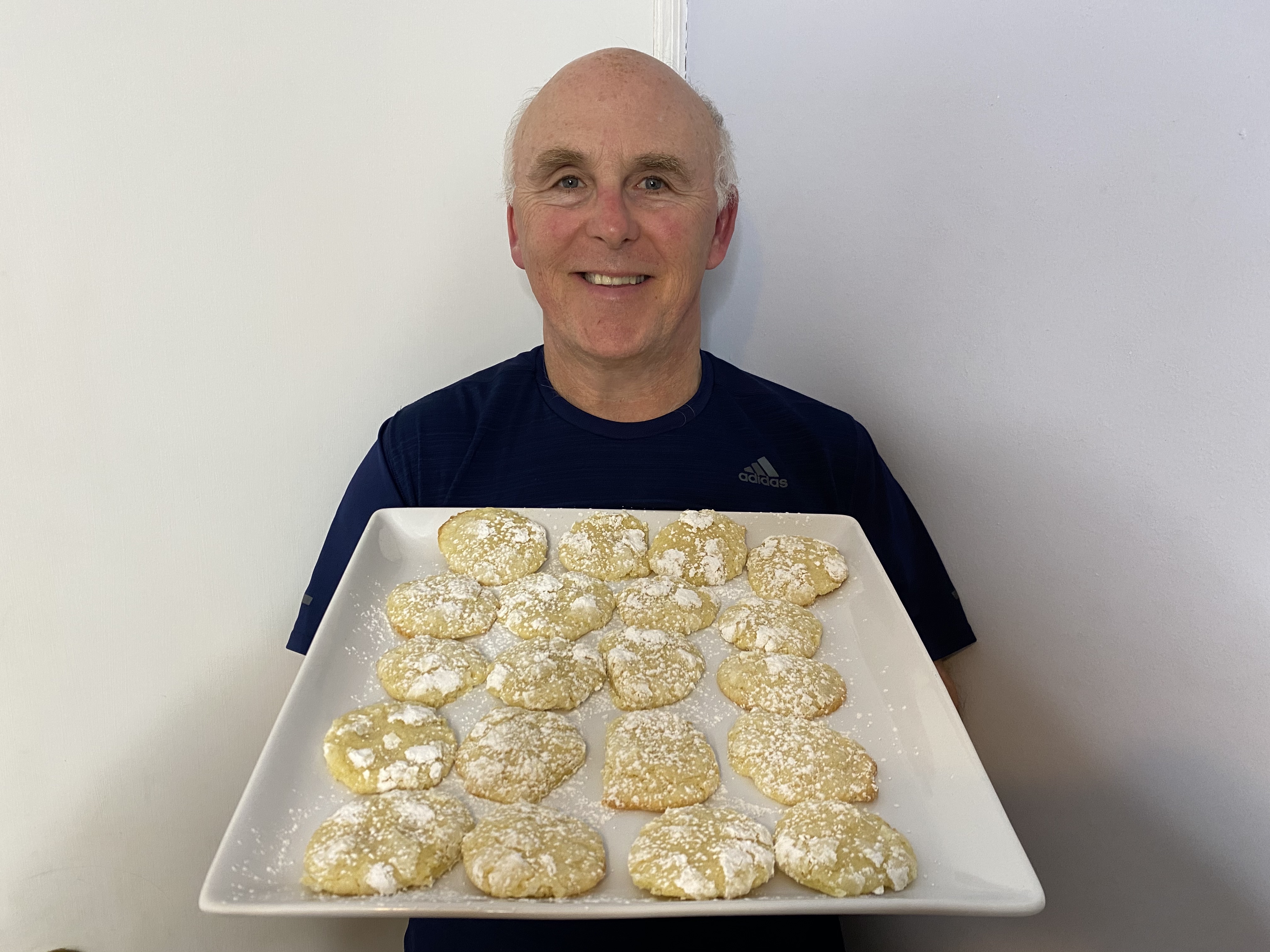 Photo of Chef Rob holding a plate of Lemon Blizzard Crinkle Cookies.