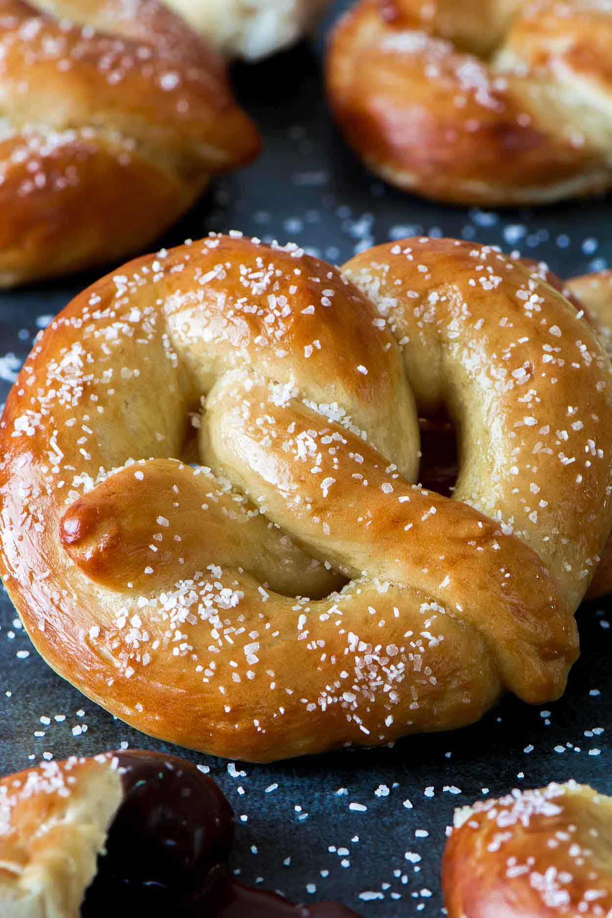 Photo of a classic large soft pretzel sprinkled with salt.