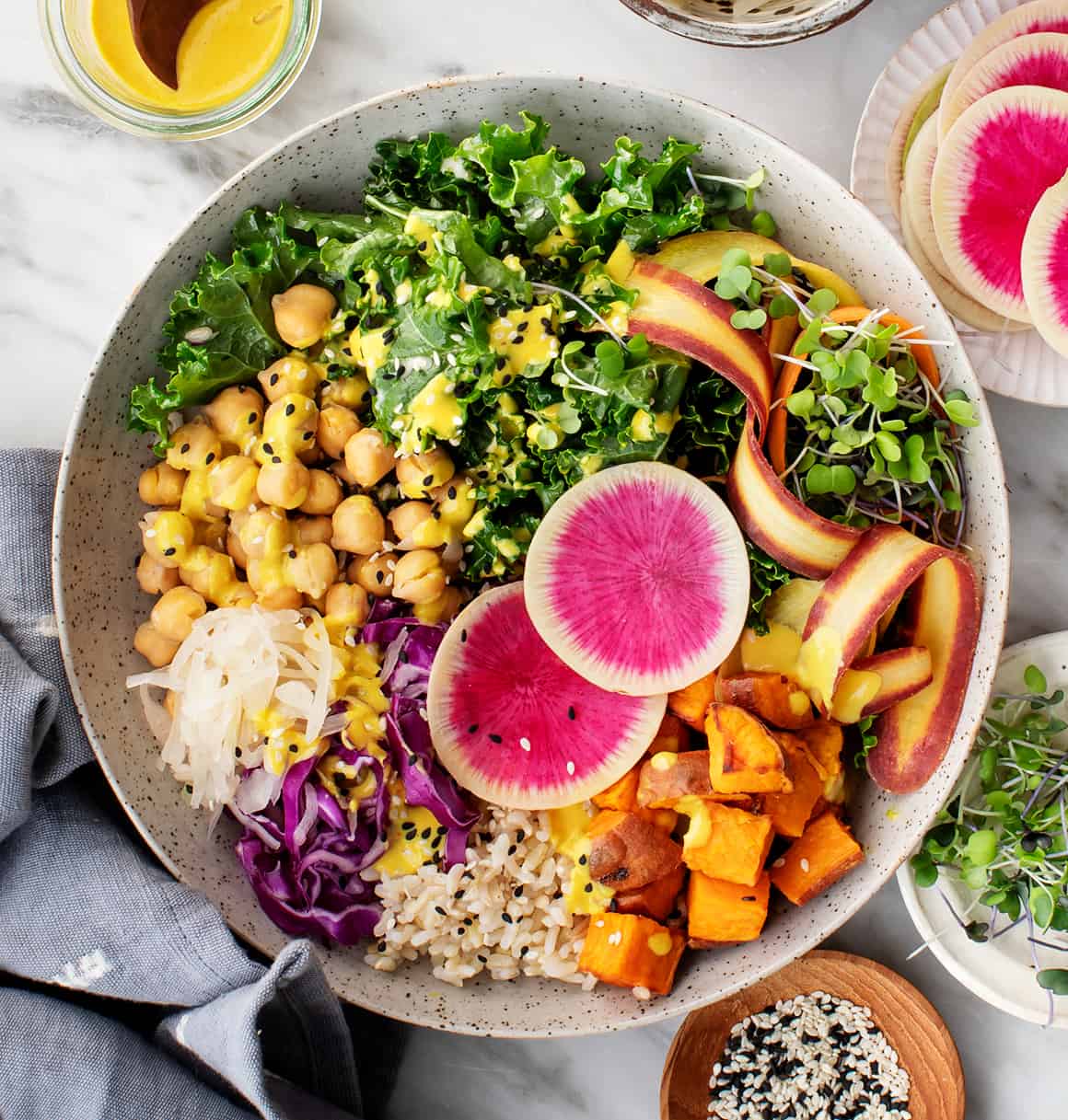 A color photo of a Buddha bowl, featuring rice, chick peas and vegetables.