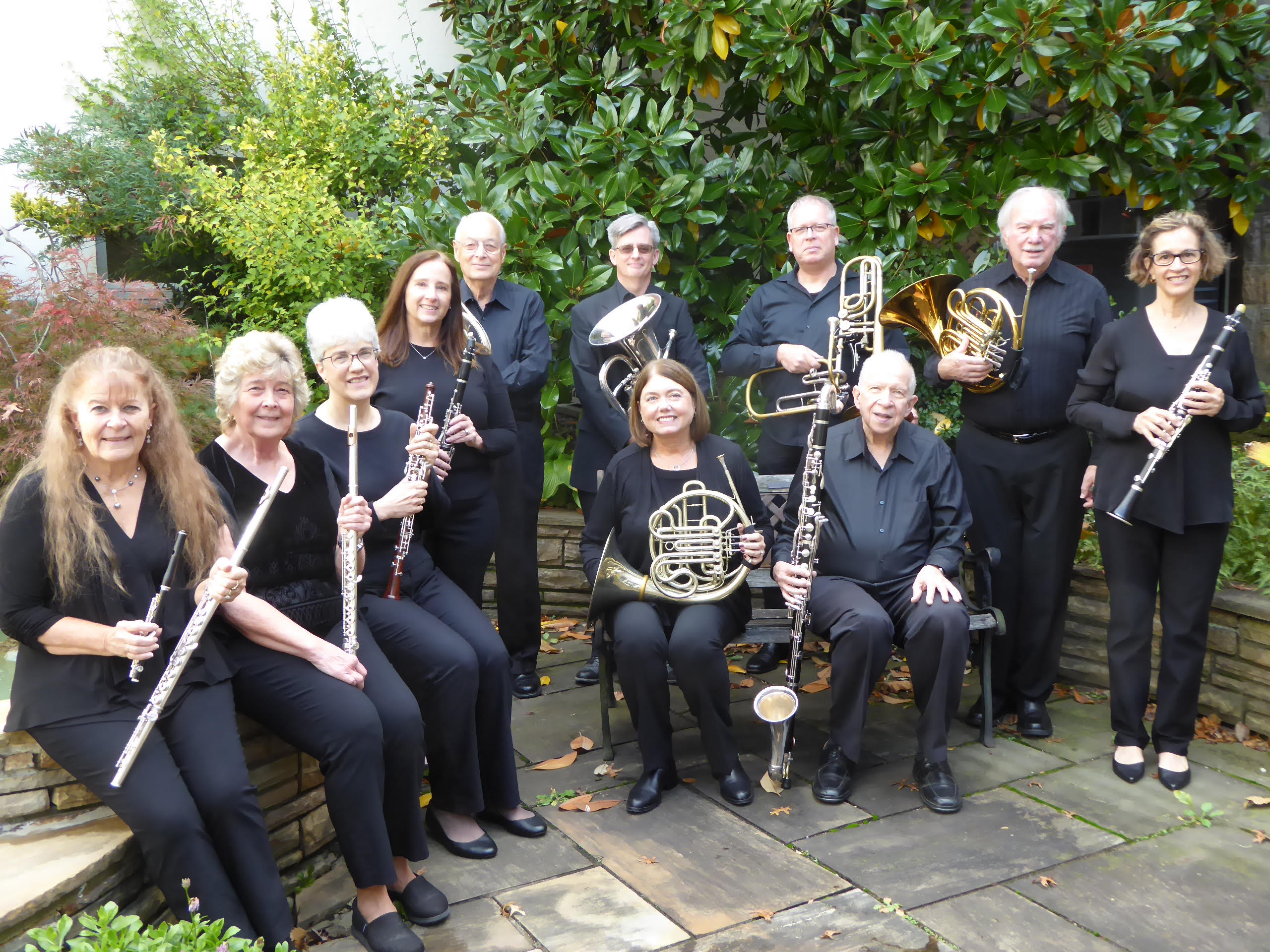 A color photograph of members of the Island Winds Ensemble holding their instruments.