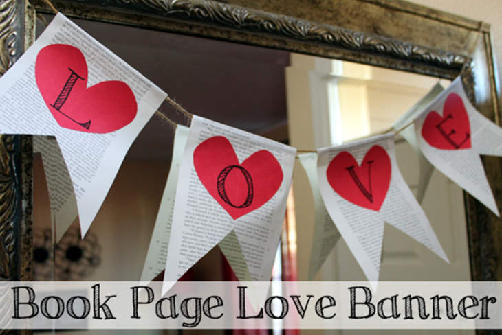 A color photo of a banner spelling out the word love that is made from upcycled book pages.