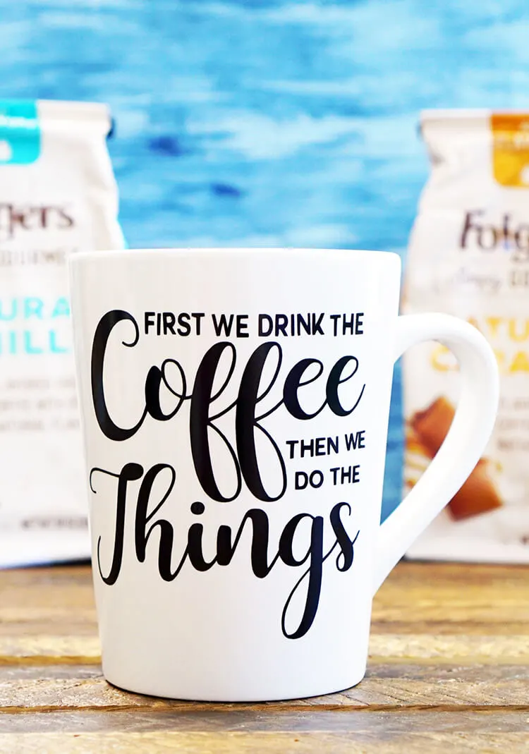 a color photo of white mug with the words "First we do coffee, then we do things."