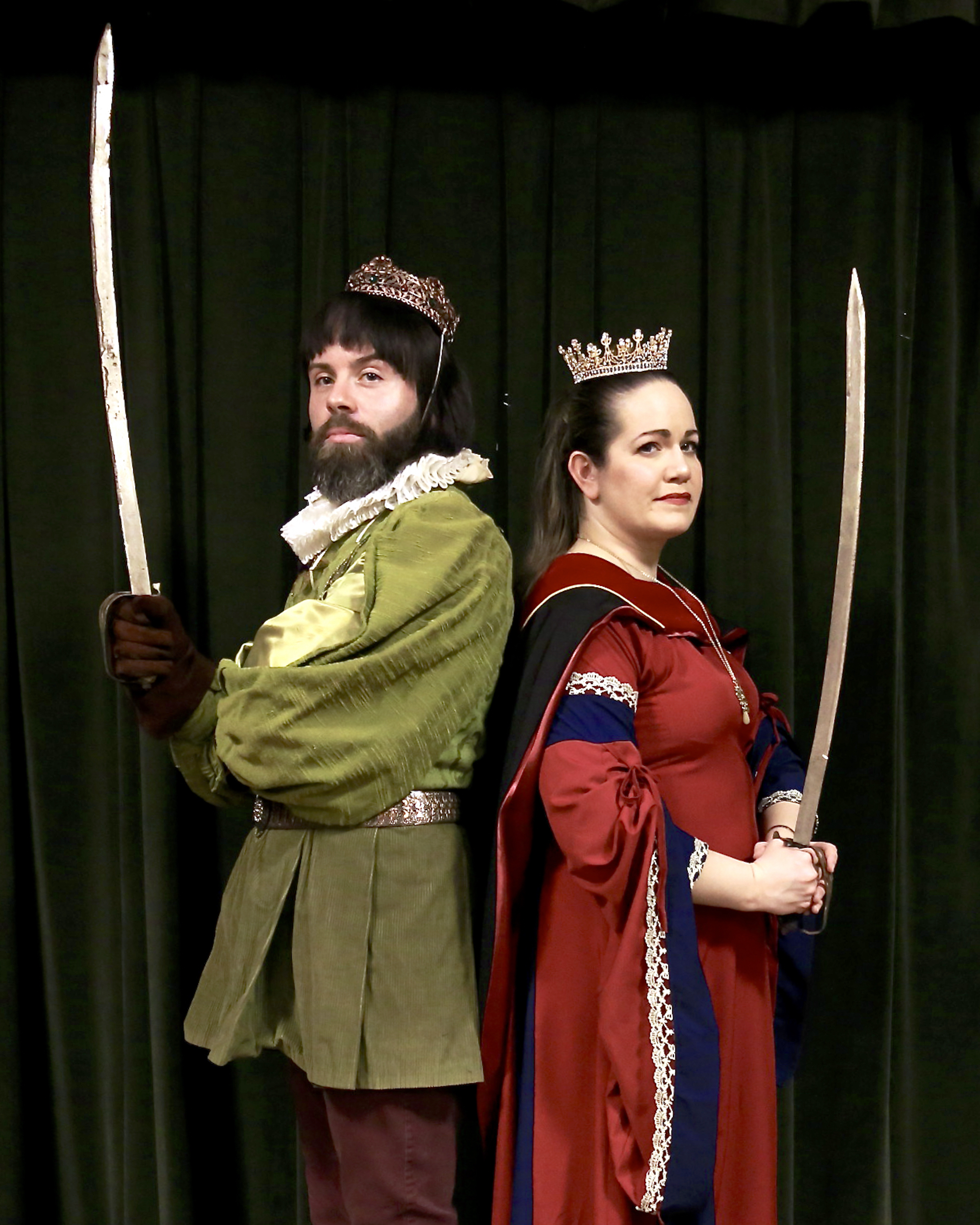 A color photo of the characters Prince Hilarion (Joseph Anthony Smith) and Princess Ida (Kara Vertucci) from Princess Ida. They are in period costume and wielding swords.