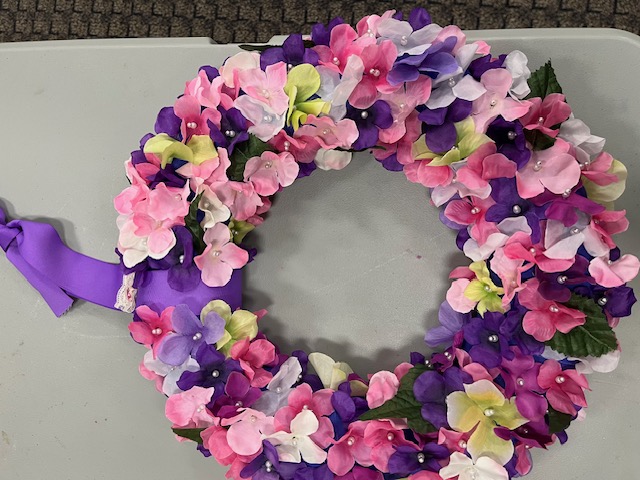 A color photo of a wreath made with silk hydrangea petals.