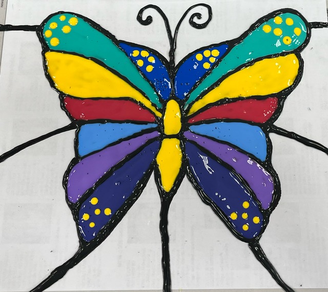 A color photo of a faux stained glass butterfly.