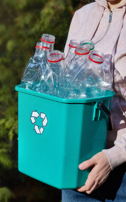 Man holding recycling container.