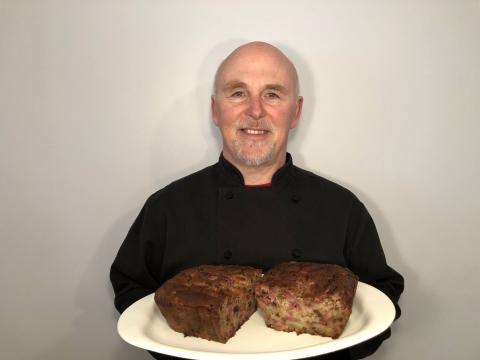 Photo of Chef Rob holding a plate of Raspberry Banana Chocolate Chip Bread.