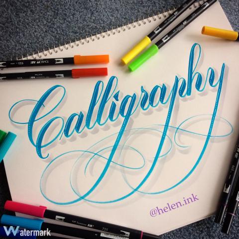 The word calligraphy written in marker on a piece of white paper.