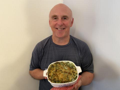 Photo of Chef Rob with a dish of Panko, Parmesan, Spinach & Artichoke Casserole.
