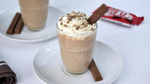 Photo of a tall glass containing a KitKat Milkshake.