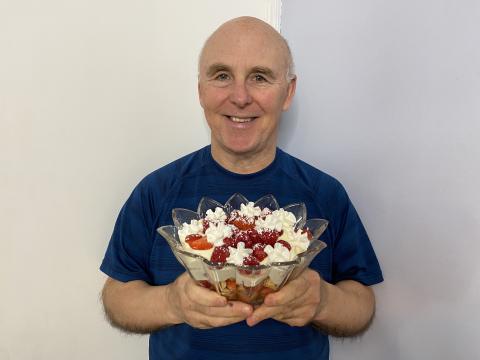 Chef Rob holding a dish containing a Berry Tiramisu Trifle.