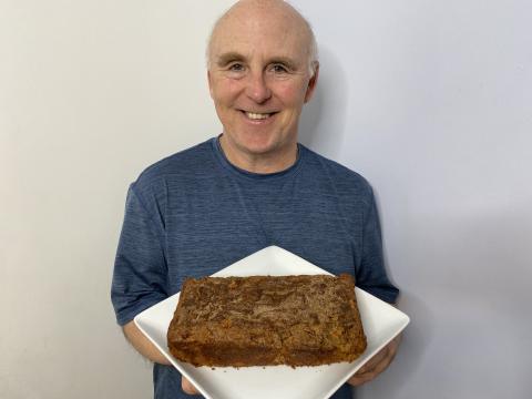 Photo of Chef Rob holding a plate of Honey Crisp Apple Snickerdoodle Bread.