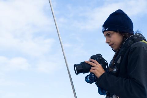 A photo of journalist Erica Cirino holding a camera.