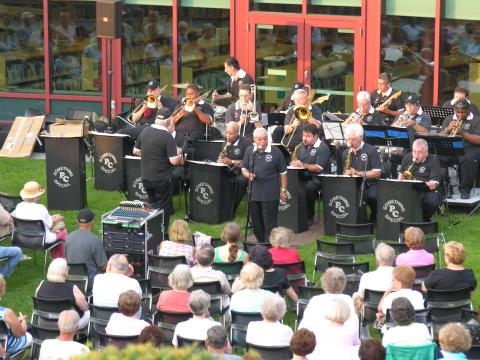 A photo of the Something Special Big Band playing in the library's outdoor garden.