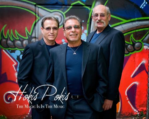 A color photo of the three members of the band Hokis Pokis.