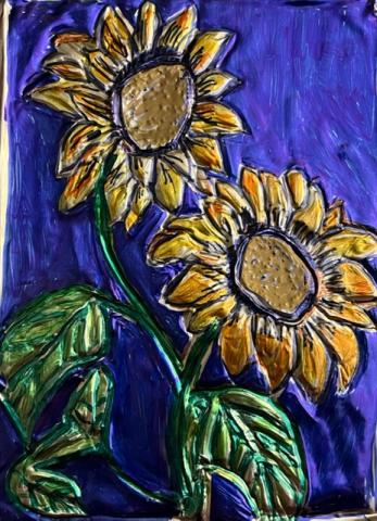 A color photo of sunflowers made by embossing metal.