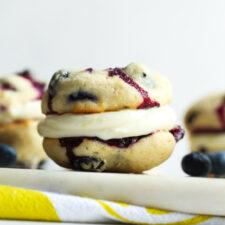 A color photo of blueberry whoopie pies with lemon filling.