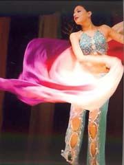 A color photo of a belly dancer in motion.