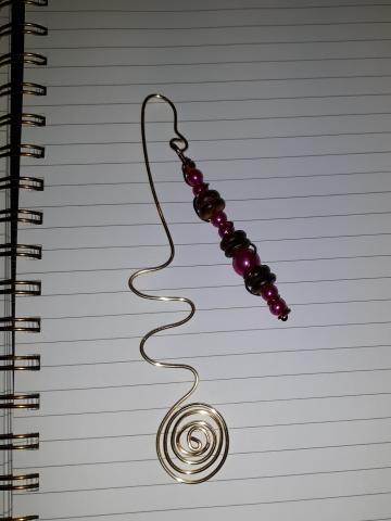 A photo of a beaded wire bookmark.