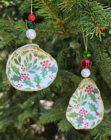 A color photo of shell ornaments hanging on a tree.