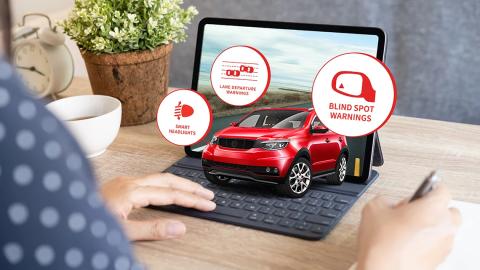 A photo of a laptop computer with a smart car on the screen.