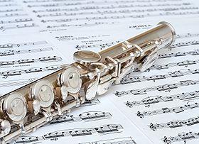 Image of a flute atop sheet music