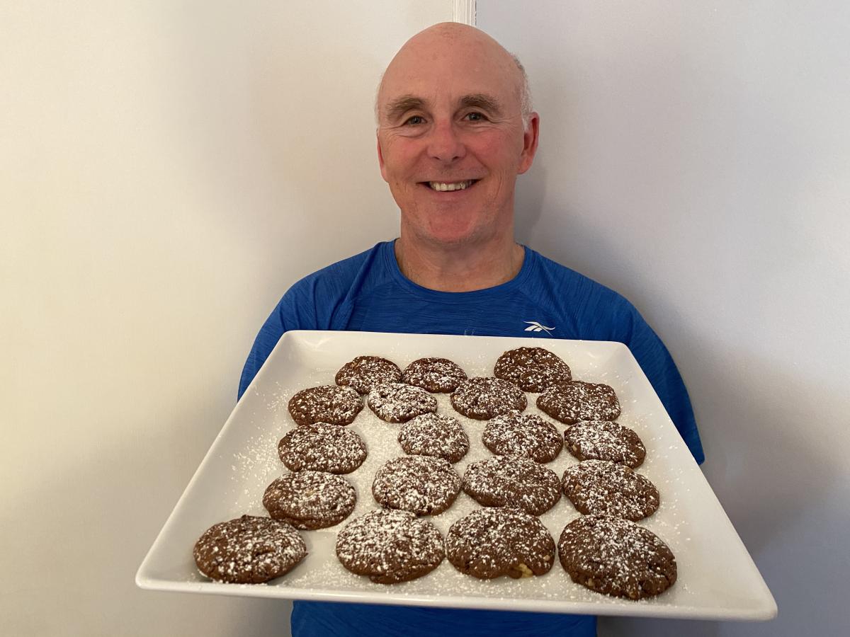 Photo of Chef Rob holding a plate of Winter Chocolate Snowstorm Cookies.