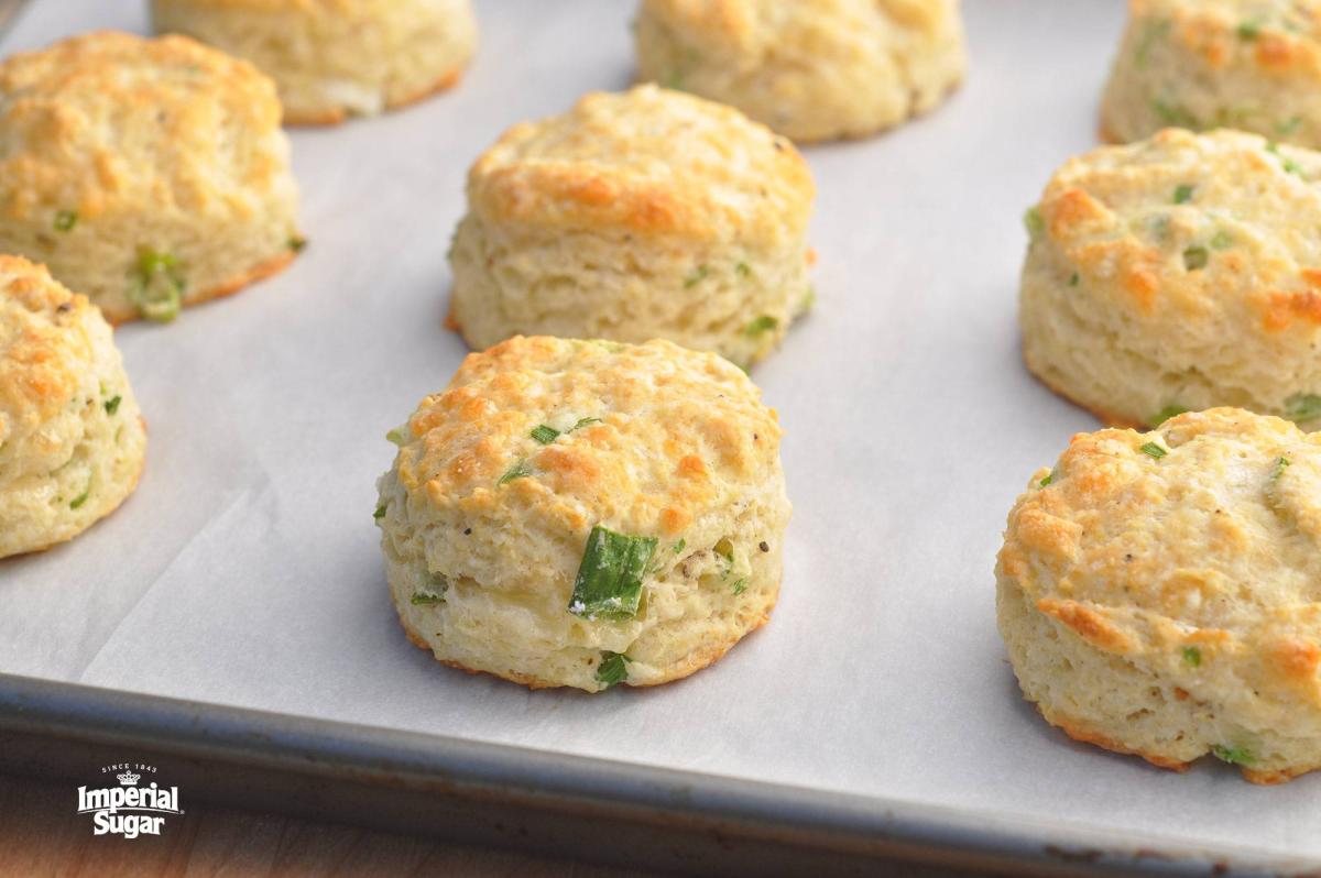 A photo of Green Onion Sour Cream Biscuits on a baking sheet.