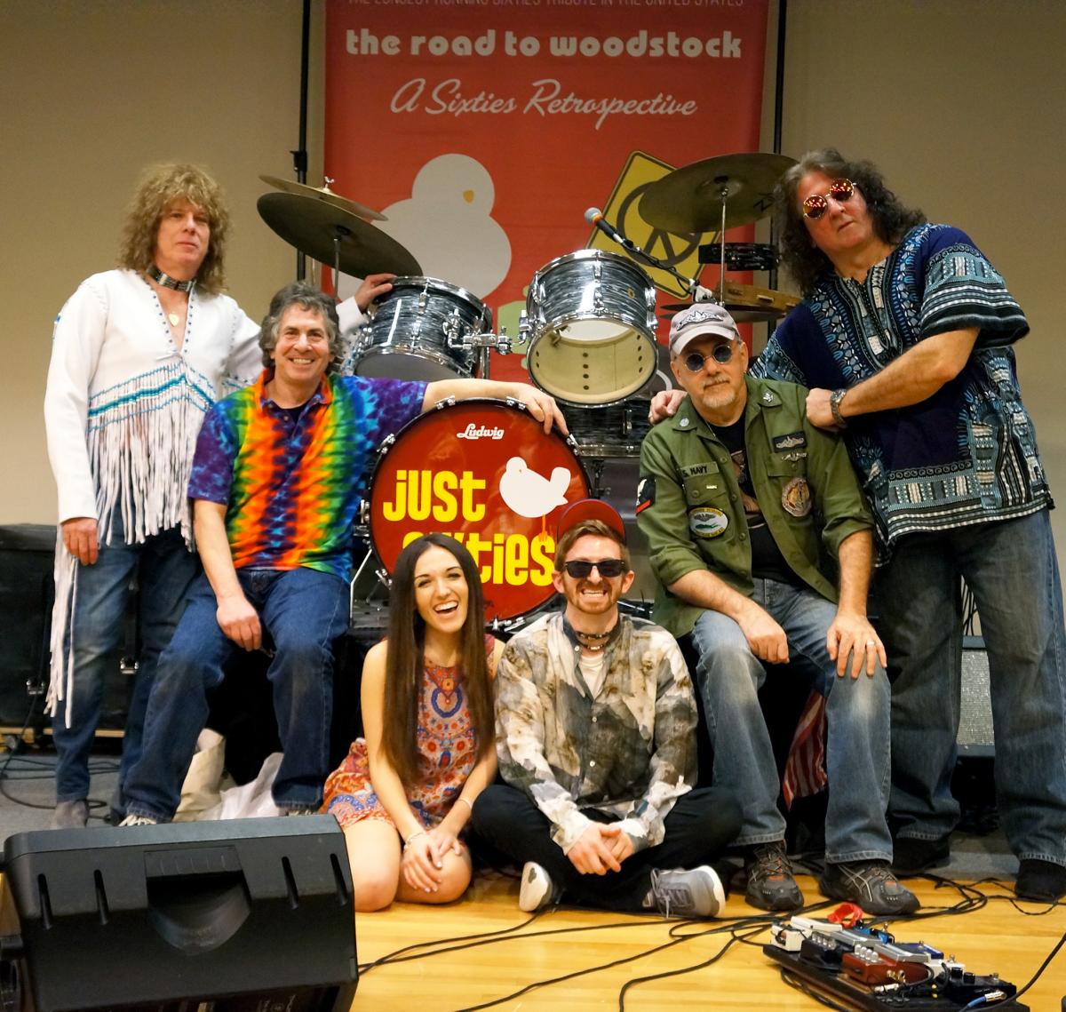 A color photo of the six members of the Just Sixties tribute band dressed in sixties attire.
